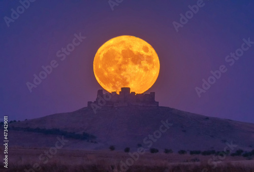 Night view of ancient castle on a mountain with full moon, Spain photo