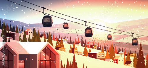 cableway in snowy mountains residential houses area ski resort christmas new year holidays celebration winter vacation