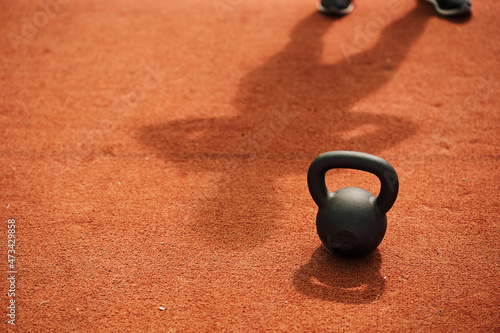 Single kettle bell with shadow of a female in the background photo