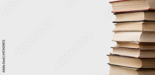Stack of books in the colored cover lay on the table . Education learning concept