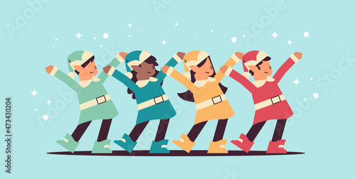 mix race elves in uniform having fun santa helpers team celebrating happy new year merry christmas holidays