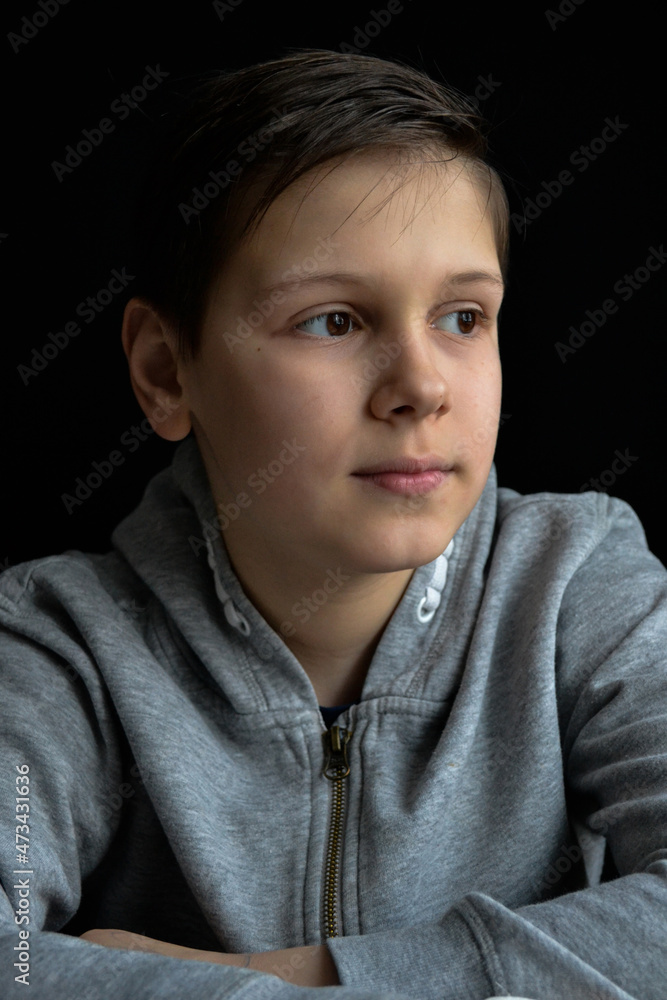 portrait of boy in front of black background portrait of boy in front of black background