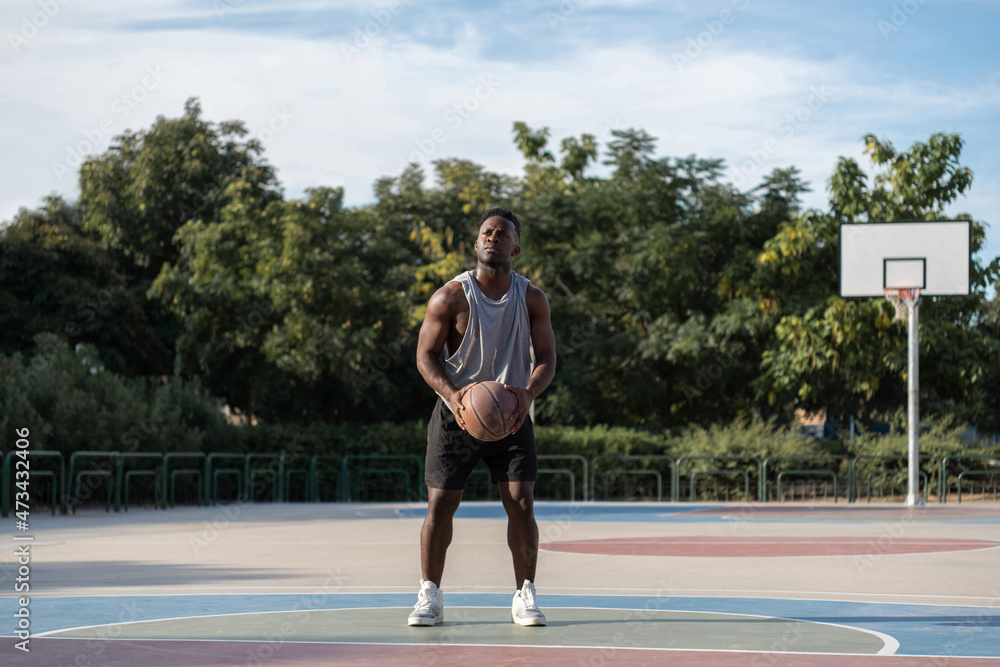 Serious black basketball player ready to perform throw Serious black basketball player ready to perform throw