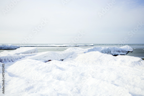 Winter seascape. Landscape of the snowy coast of the Baltic Sea. Christmas, winter. Blocks of ice. © Natalya