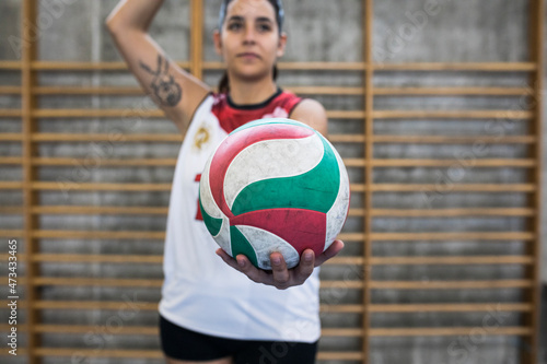 Attentive female volleyball player serving ball while tournament