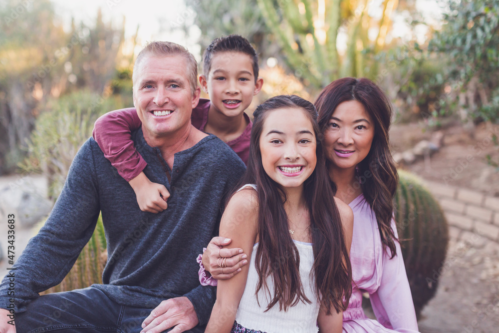 Asian and white mixed family - mother, father, son and daughter. Asian and white mixed family - mother, father, son and daughter.