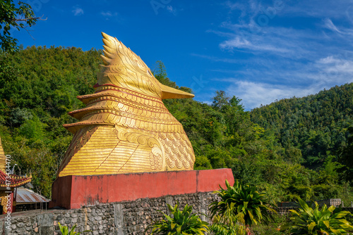 Big golden statue of chicken at Ko Yin Lay Monastery, Kengtung Myanmar photo