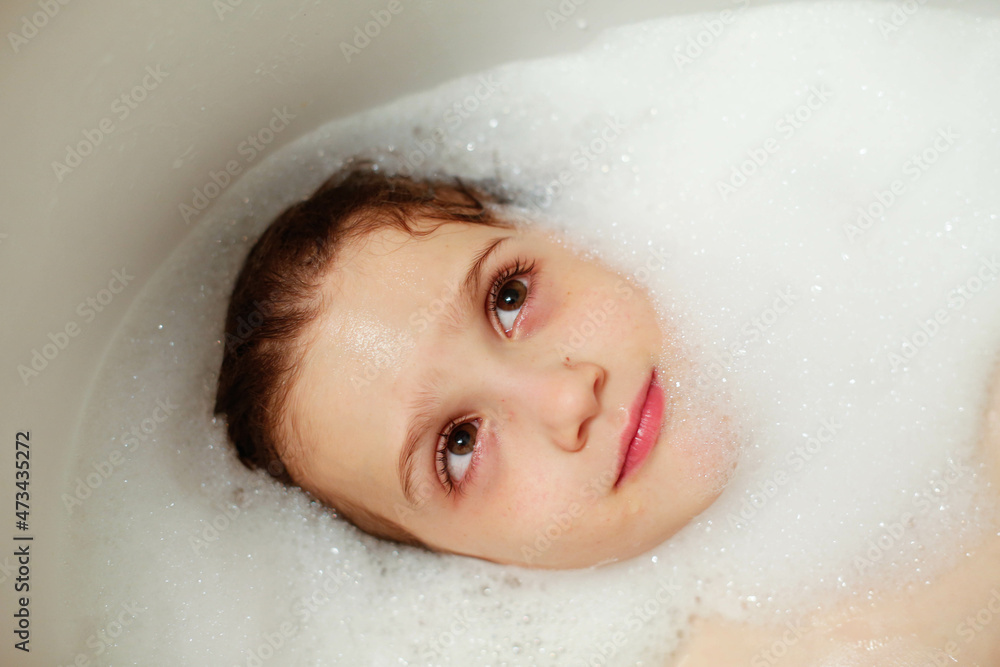 Overhead view of a cheerful boy in a bathtub Overhead view of a cheerful boy in a bathtub