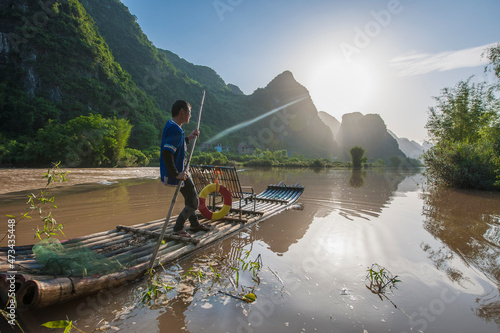 fisherman on traditional raft on the Yulong river close to Yangshuo photo