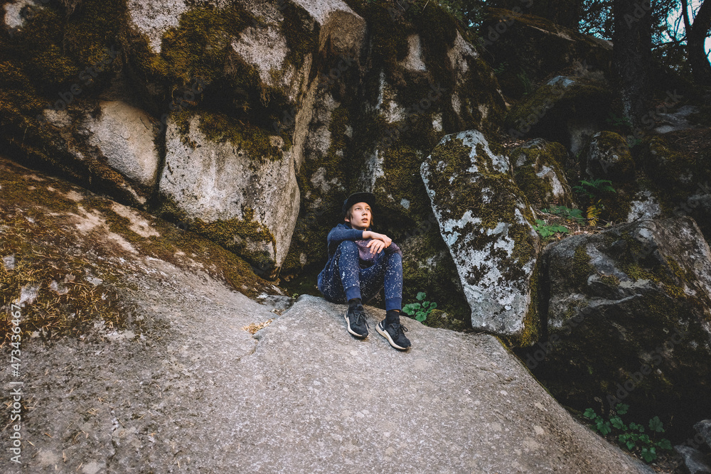 Young Boy Rests on a Boulder while Hiking in Yosemite Young Boy Rests on a Boulder while Hiking in Yosemite