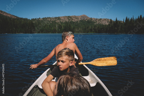 Three Boys Head out on a journey in a small Canoe photo