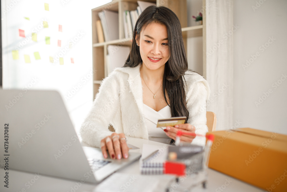 Businesses woman hand using a credit card and smartphone for buying online shopping, online payment, shopping online, e-commerce, internet banking, spending money. Businesses woman hand using a credit card and smartphone for buying online shopping, online payment, shopping online, e-commerce, internet banking, spending money.