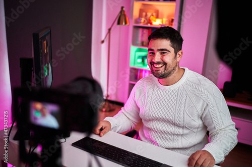 Young fat streamer on a room with multicolor lights photo