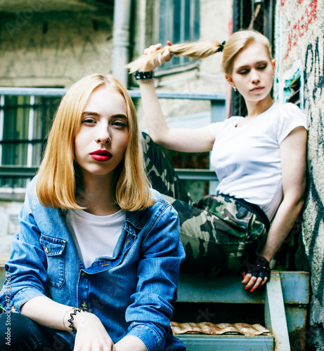 couple of teenage girls ouyside on streets chilling, lifestyle people concept photo