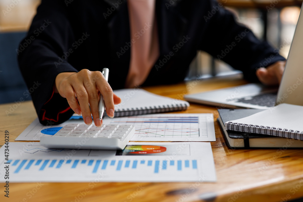 Business Woman working at office with documents on his desk, doing planning analyzing the financial report, business plan investment, finance analysis concept Business Woman working at office with documents on his desk, doing planning analyzing the financial report, business plan investment, finance analysis concept