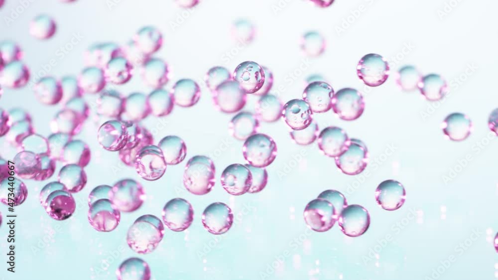 Super Slow motion Shot of Neon Hydrogel Balls Bouncing on Glass at 1000fps.