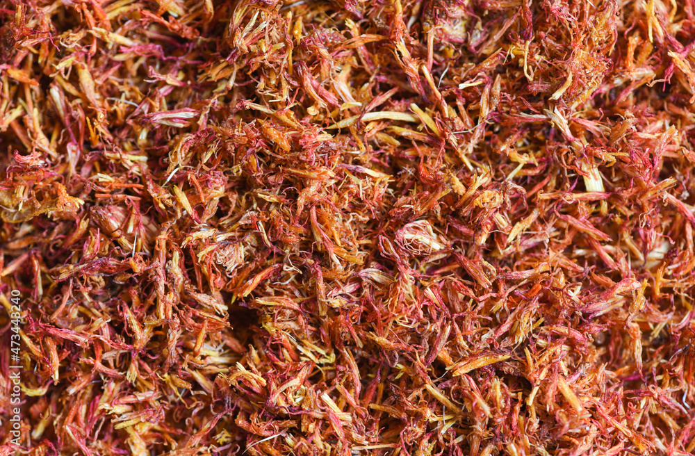 Fototapeta premium Dried safflower for herbal tea on background, dry safflower petals, Saffron substitute
