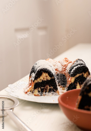 Marble Cake with Coffee with Powder Sugar and Kitchen Vintage Utensil, White Bakery Concept photo