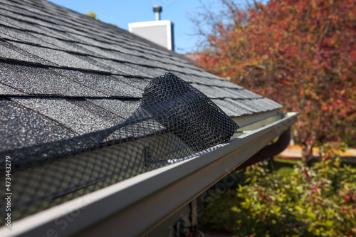Tablou canvas Roll of plastic mesh guard over gutter on a roof to keep it free of leaves, shal