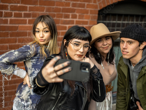 Young Indigenous friends making a selfie outdoors photo