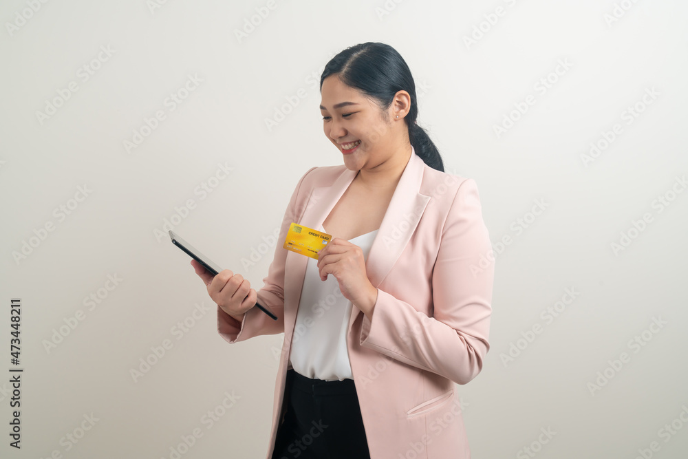 Asian woman using smartphone with hand holding credit card Asian woman using smartphone with hand holding credit card