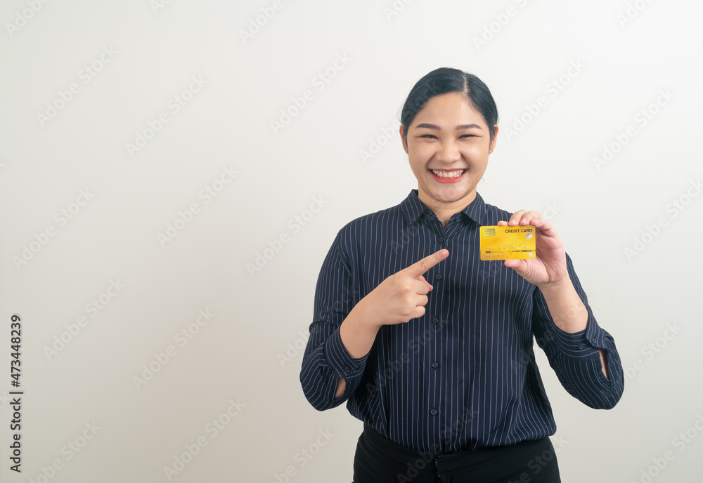 Asian woman holding credit card with white background Asian woman holding credit card with white background