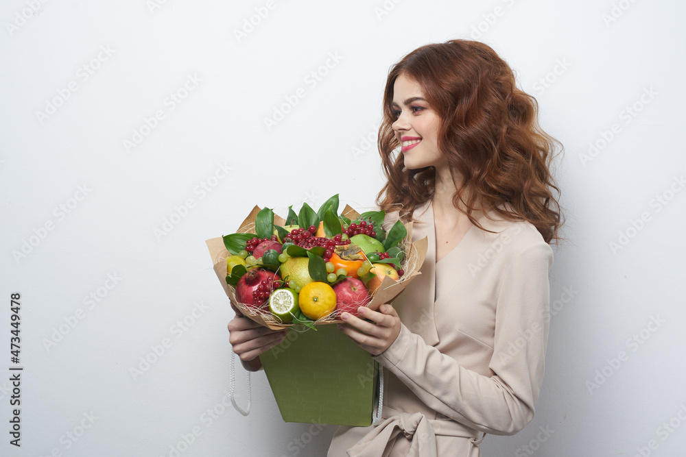 pretty woman bright makeup attractive look a bouquet of fruits light background pretty woman bright makeup attractive look a bouquet of fruits light background