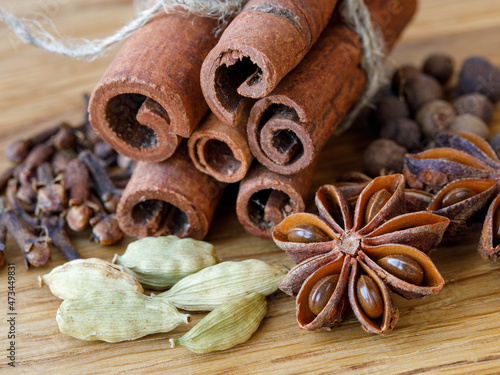 Fotografie Collection of spices for mulled wine and pastry on the wooden table
