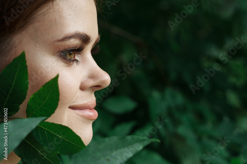 attractive woman Cosmetology nature green leaves glamor close-up