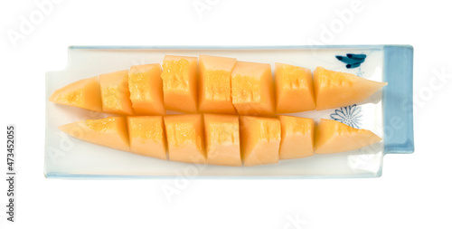 Orange cantaloupe melon fruit sliced on dish isolated on white background ,include clipping path
