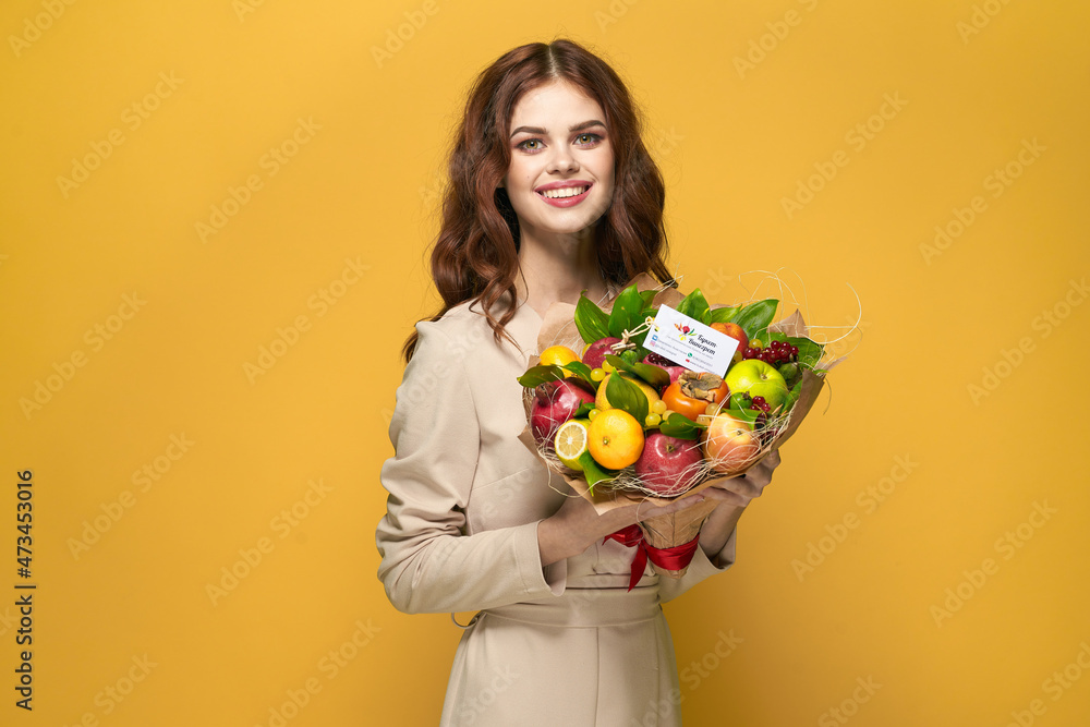 cheerful woman beige coat fruit bouquet in hands present yellow background cheerful woman beige coat fruit bouquet in hands present yellow background