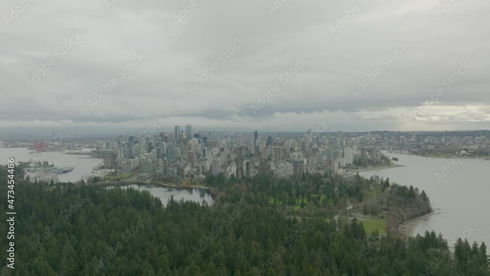 Aerial view of Downtown Vancouver Skyline And Stanley Park During Sunset in a cloudy Day in 4K Aerial view of Downtown Vancouver Skyline And Stanley Park During Sunset in a cloudy Day in 4K