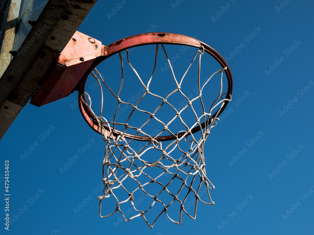 basketball hoop and net against blue sky