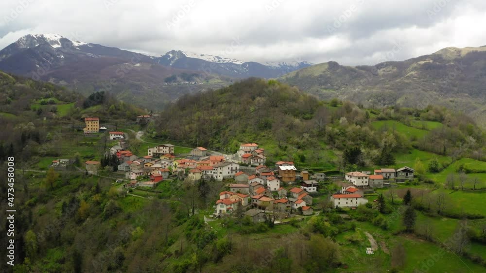 Aerial Panning Residential Houses On Hill Top, Drone Descending Over Green Landscape - Apennine Mountains, Italy Aerial Panning Residential Houses On Hill Top, Drone Descending Over Green Landscape - Apennine Mountains, Italy