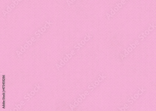 ピンク色の和柄模様（紗綾形）の和紙の質感のある背景