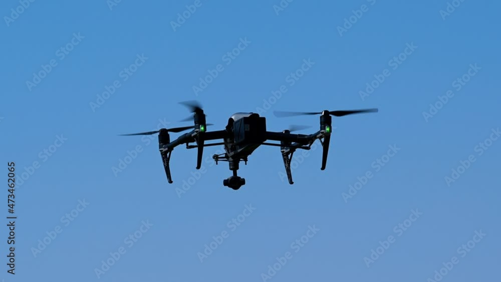 The drone hovering on a bright sunny day, Drone flying, Drone camera, quadcopters The drone hovering on a bright sunny day, Drone flying, Drone camera, quadcopters