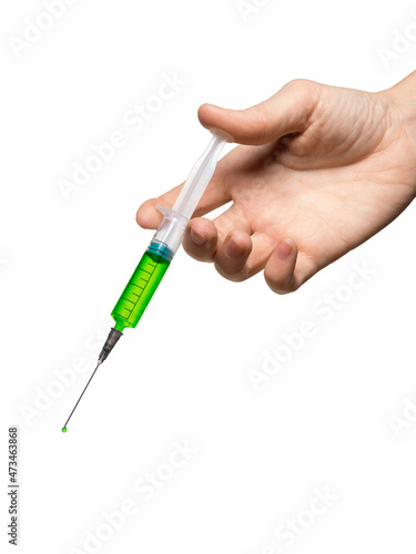 Disposable 5 ml syringe in human hand, close up, vertical photo, isolated on white.