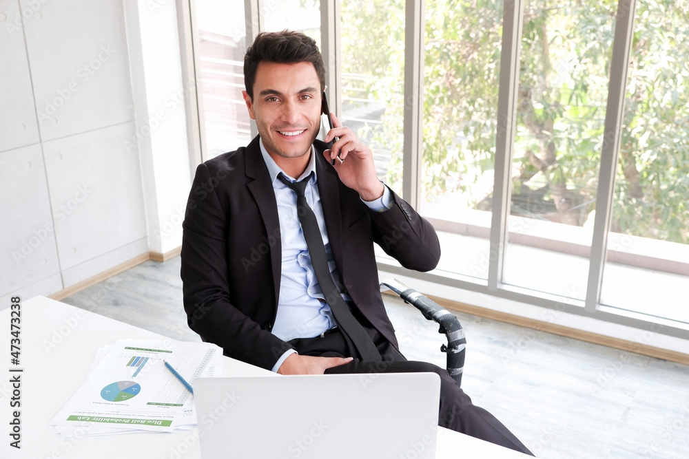 business caucasian man sitting in working with talking smart phone in workplace business caucasian man sitting in working with talking smart phone in workplace