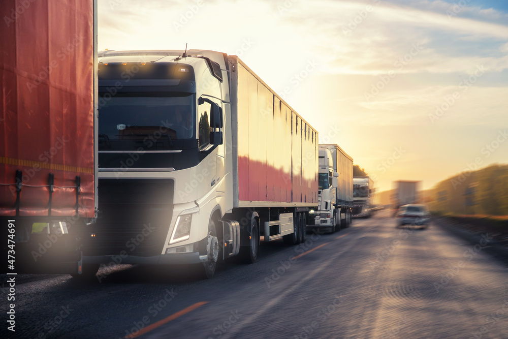 Truck with container on highway with sun light, concept cargo transportation. Blur move effect Truck with container on highway with sun light, concept cargo transportation. Blur move effect