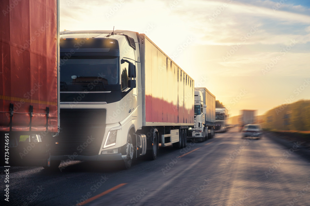 Truck with container on highway with sun light, concept cargo transportation. Blur move effect