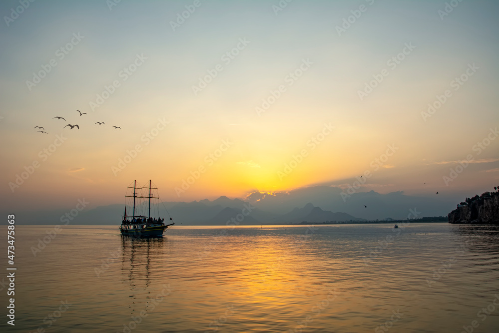 Antalya harbor over sunset sky and high mountains. Beautiful view of the Antalya Kaleiçi Old town (Kaleici)