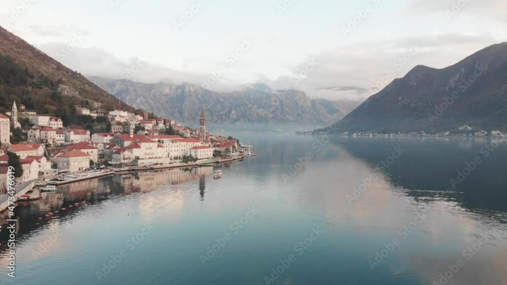 Beautiful mountains and clouds approaching against the background of the city of Perast Beautiful mountains and clouds approaching against the background of the city of Perast