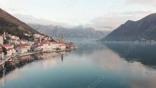 Beautiful mountains and clouds approaching against the background of the city of Perast