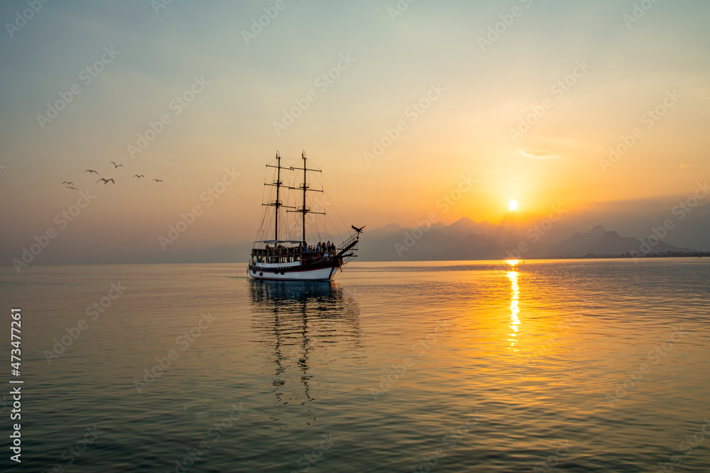 Antalya harbor over sunset sky and high mountains. Beautiful view of the Antalya Kaleiçi Old town (Kaleici)