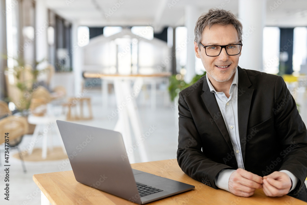 Male professional with laptop sitting at office Male professional with laptop sitting at office
