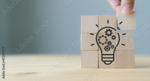 Idea creation and generating a great idea concept. Innovations and creativity process. Brainstorming ideas for a new project. Business startup and problem solving banner. Wooden cubes with ideas icon
