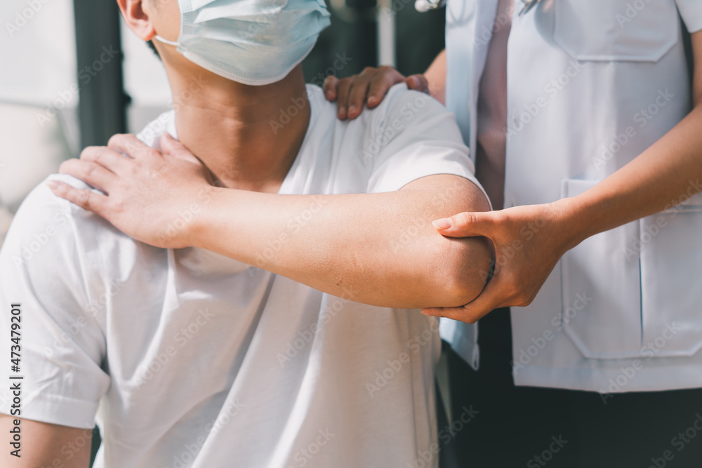 Naklejka premium Physiotherapist doing healing treatment on man's arm. arm pain patient, treatment, medical doctor, massage therapist.office syndrome