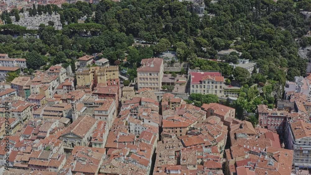 Nice France Aerial v15 birds eye view drone flyover castle hill waterfall from old city neighborhood toward quartier du port at daytime - July 2021 Nice France Aerial v15 birds eye view drone flyover castle hill waterfall from old city neighborhood toward quartier du port at daytime - July 2021