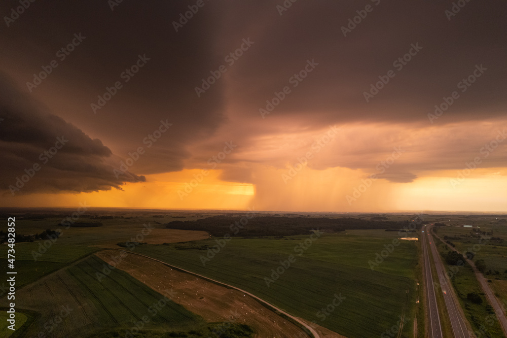 Aerial summer evening stormy view of fields before the storm