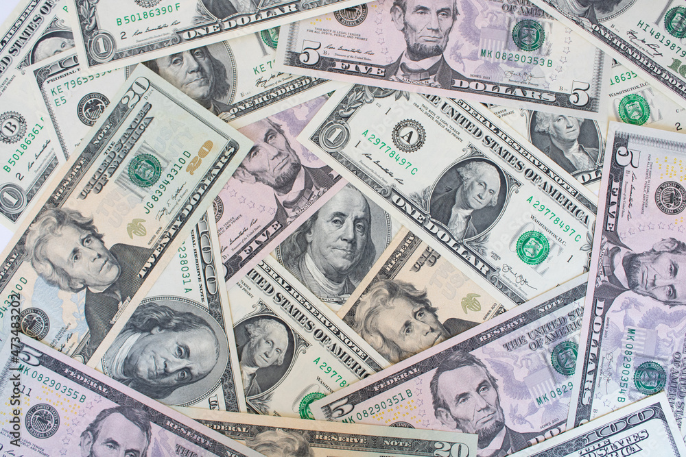 A pile of US banknotes. Cash of dollar bills, dollar background image A pile of US banknotes. Cash of dollar bills, dollar background image